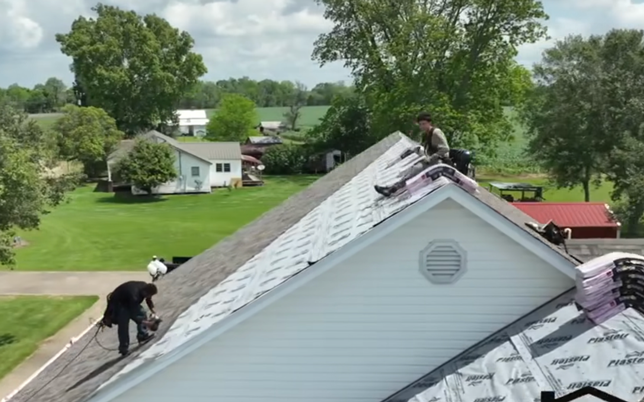 New shingles being put onto a roof.